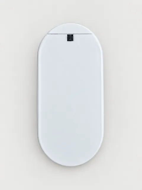 Closed back of the larger door sensor showing the battery cover and small notch